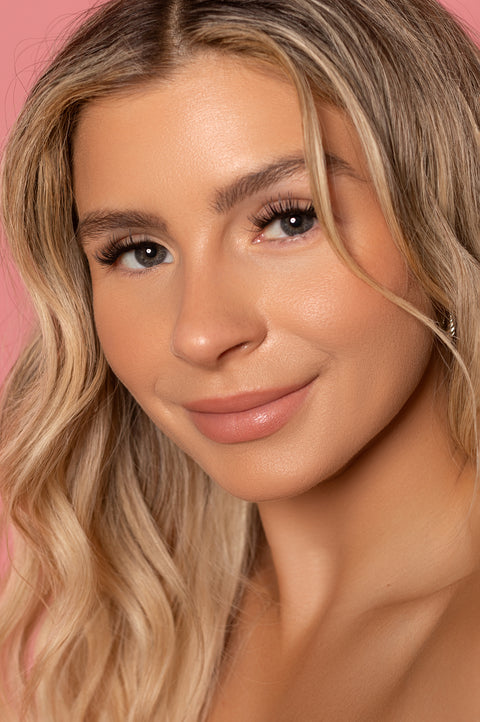 A close up of a woman wearing Wispy Lash Segments
